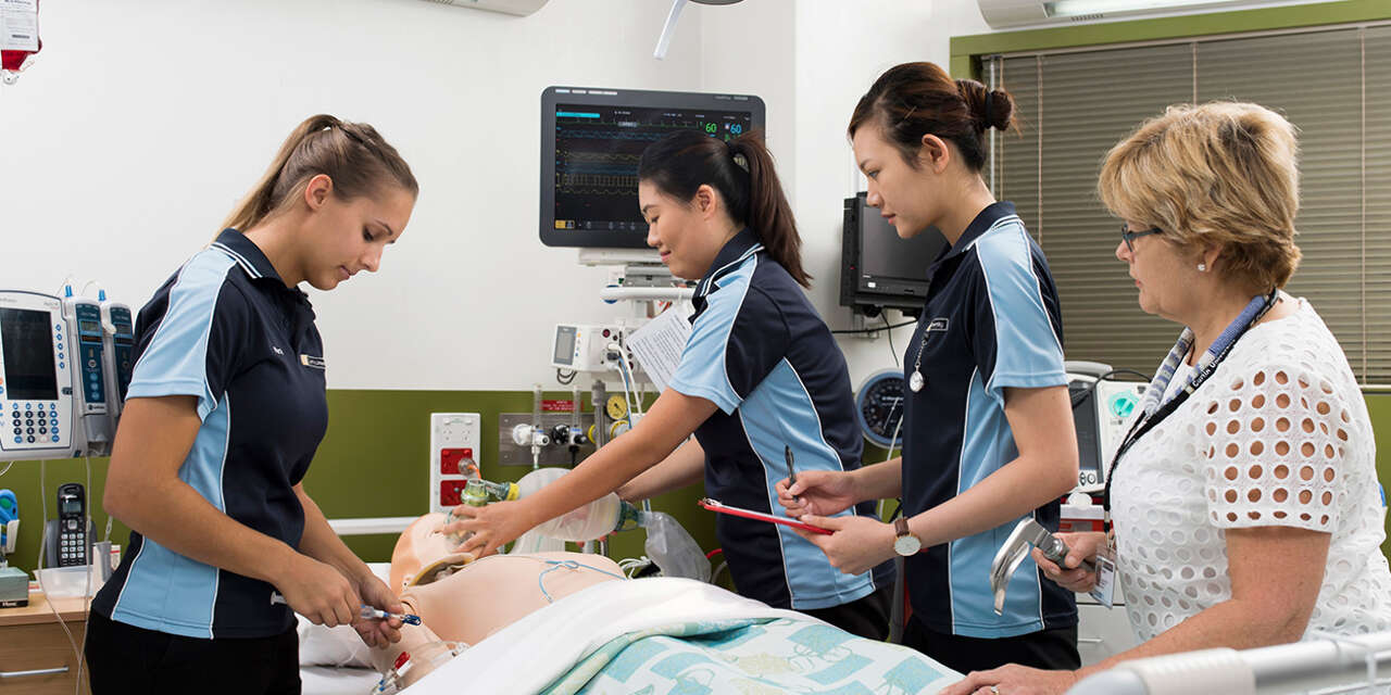 Students using a bag valve mask on a dummy