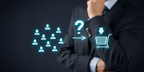 Business man, standing in front of a computer graphic of a shopping cart