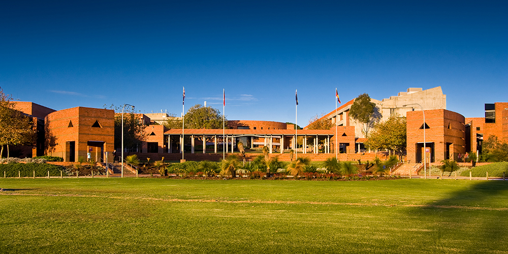 The front of Curtin building 100, taken across the grass