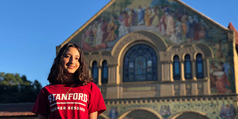 Marketing and Advertising student Mary Bocarro standing in front of a Stanford university building