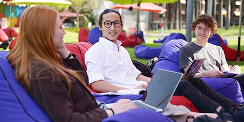 Three students sitting on beanbags