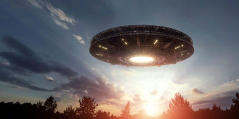 Unidentified flying object flying over trees