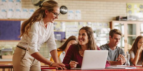 Teacher helping students